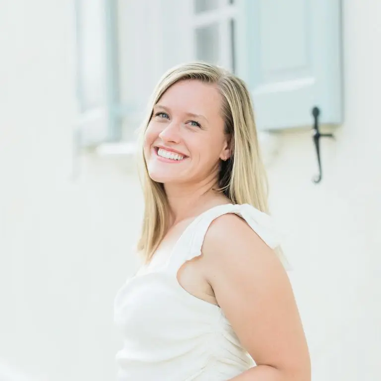 A professional headshot of a smiling woman set against a light background, taken by a Chicago family photographer.