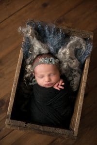 Newborn baby in a beautiful wooden box